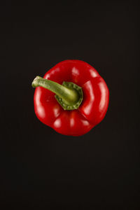 Close-up of red bell pepper against black background