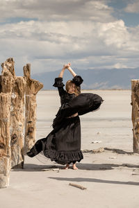 Portrait of woman dancing in desert