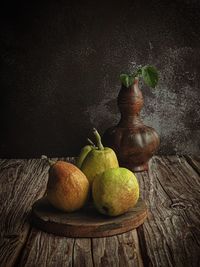 Various fruits on table against wall