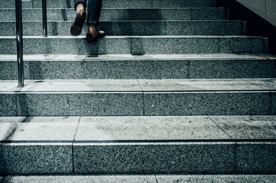 Low section of woman walking on stairs