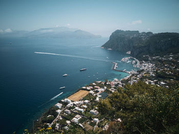 High angle view of sea and cityscape against sky