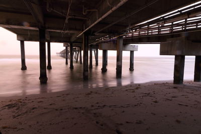View under pier on beach 