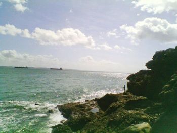 Scenic view of sea against cloudy sky