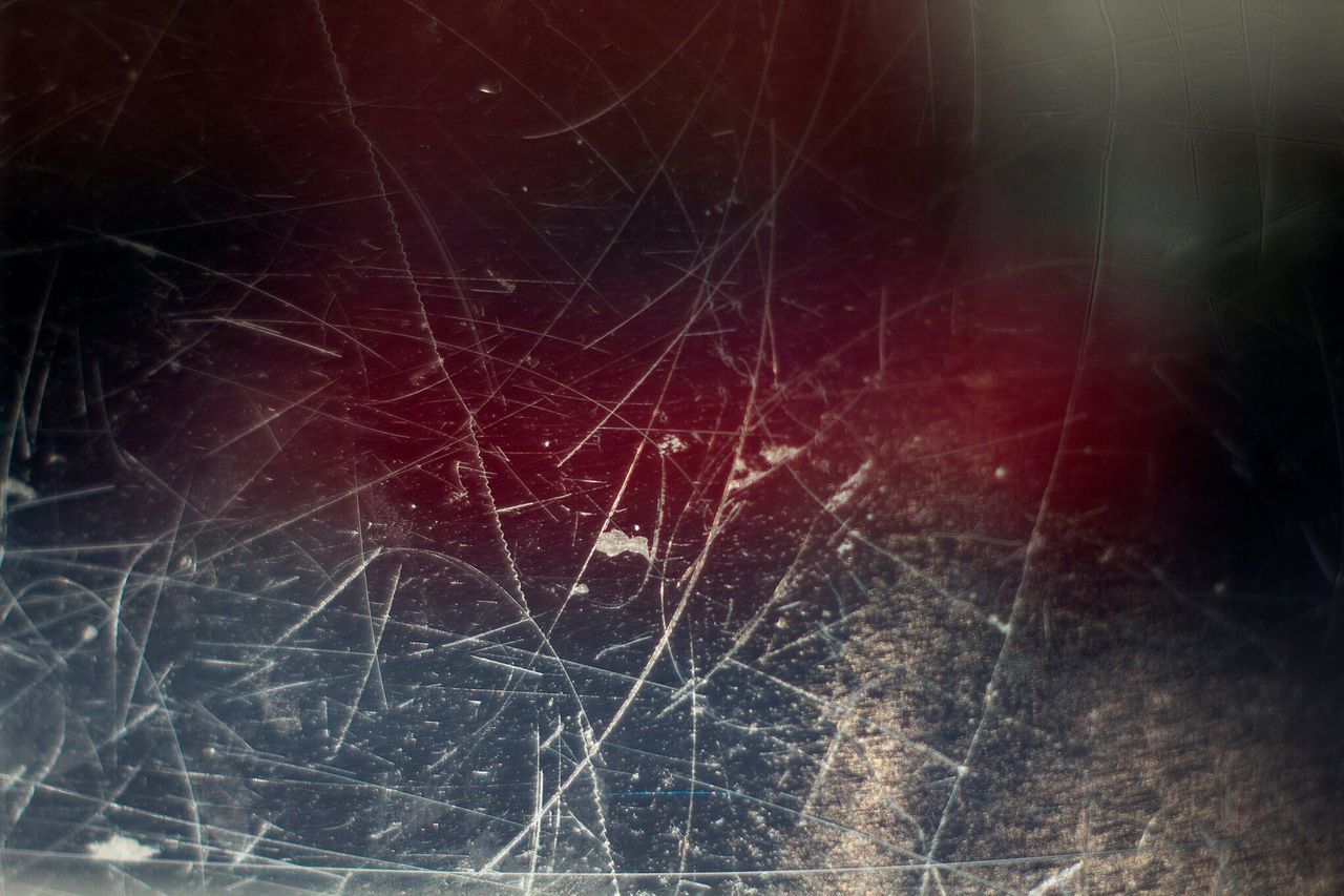 CLOSE-UP OF WET SPIDER WEB IN DARK