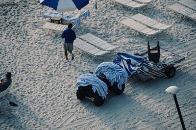 High angle view of towels and parasol on vehicle at beach