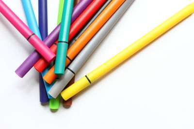 High angle view of colored pencils on white background