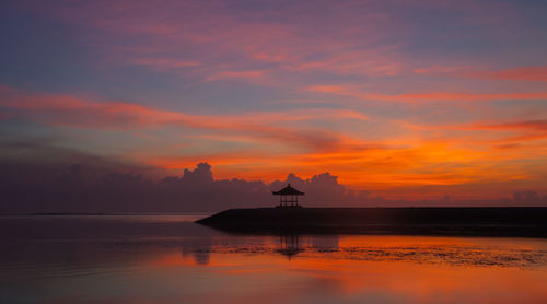 Scenic view of sea against orange sky