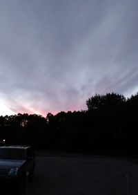 Car on road against sky during sunset