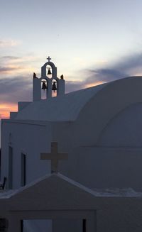 Low angle view of bell tower against sky during sunset