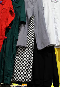 Tilt image of clothes hanging on white wall