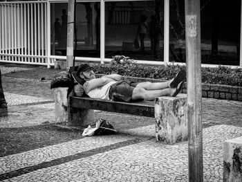 Rear view of man sleeping in house