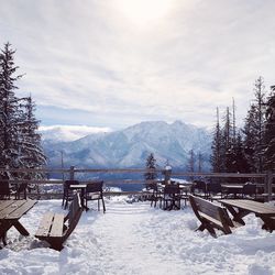 Scenic view of snow covered field against sky