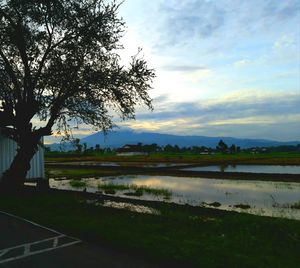 Scenic view of lake against sky at sunset