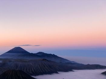 Scenic view of snowcapped mountains against sky during sunset