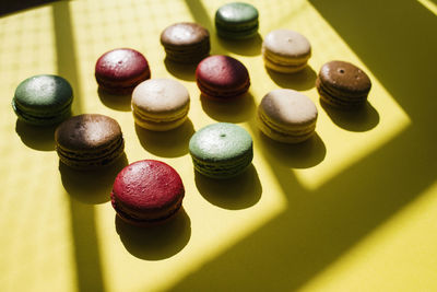 High angle view of colorful macaroons arranged on table