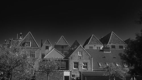 Houses and buildings against sky at night