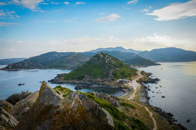 Scenic view of sea and mountains against sky