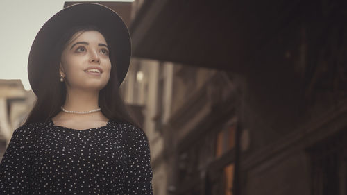 Portrait of young woman standing outdoors