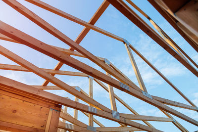 Low angle view of metallic structure against sky