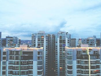 High angle view of city against cloudy sky