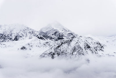Scenic view of snow covered mountains against sky