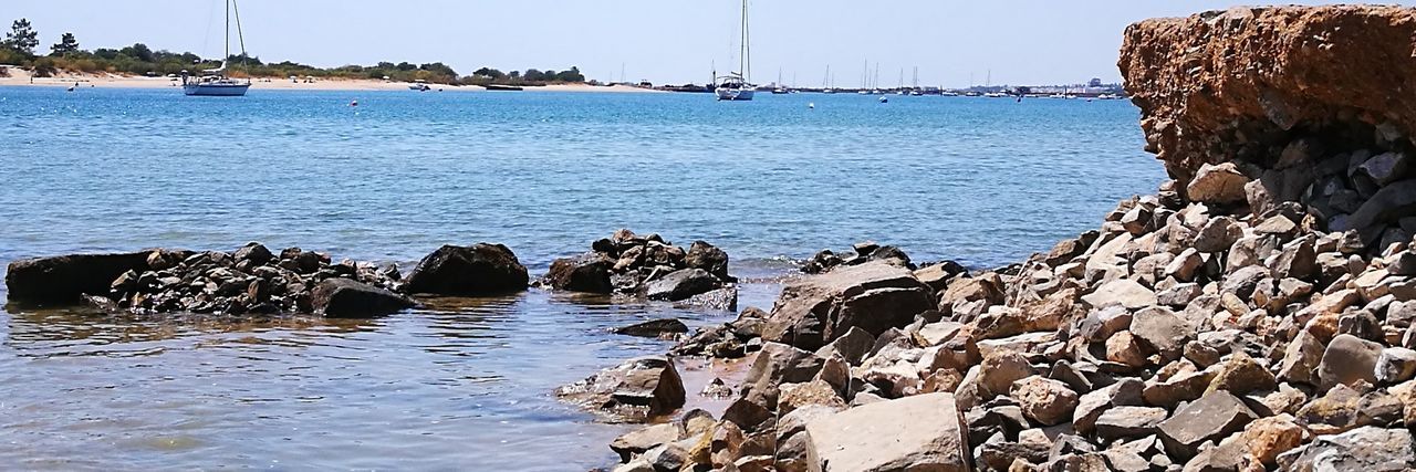 water, rock - object, sea, nature, day, outdoors, no people, beauty in nature, tranquility, sky, scenics, groyne, harbor, beach, nautical vessel, animal themes