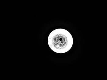 Low angle view of illuminated light bulb in the dark