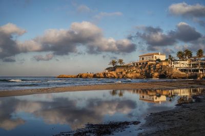 Scenic view of sea and buildings against sky