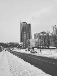 Road in city against clear sky during winter