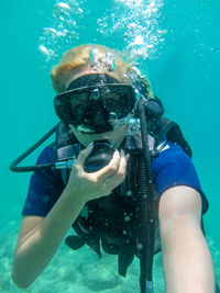 Midsection of man swimming in sea