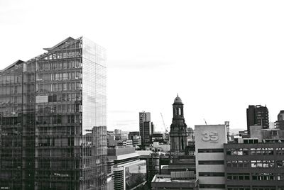 Modern buildings in city against clear sky