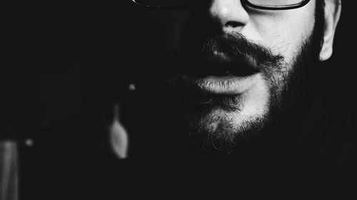 Close-up of bearded man in darkroom