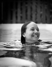 Cheerful woman swimming in pool
