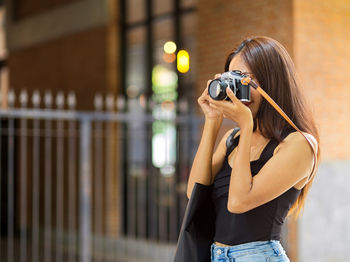 Woman photographing with camera