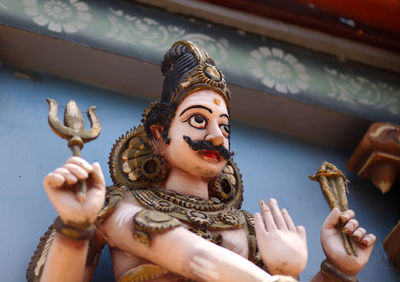 Statue of buddha against building