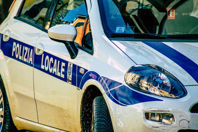 Close-up of blue car on street