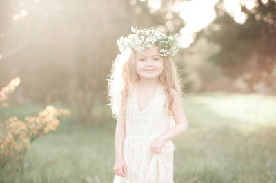 Portrait of girl wearing wreath at park