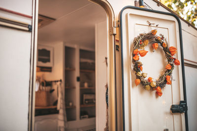 Close-up of flower arrangement hanging on door