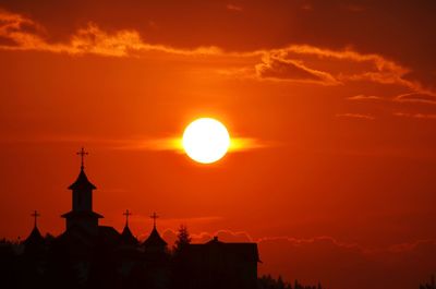 Silhouette building against sky during sunset