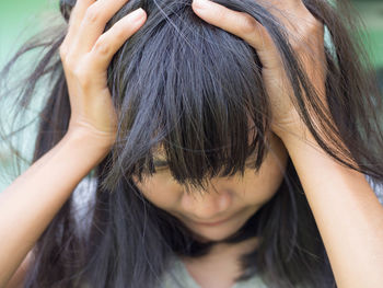 Close-up of depressed woman suffering from a headache