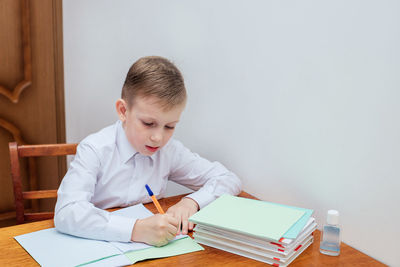 Boy sitting on table