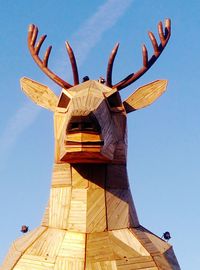 Low angle view of sculpture against clear blue sky