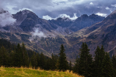 Scenic view of mountains against cloudy sky