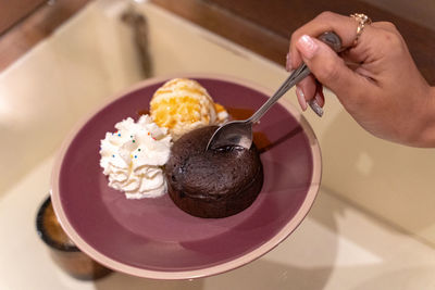 Midsection of woman holding ice cream in plate