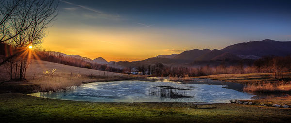 Scenic view of lake against sky during sunset