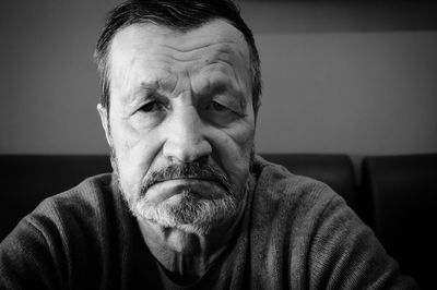 Close-up portrait of elderly man at home