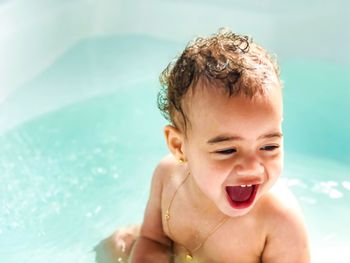 Portrait of shirtless boy in swimming pool