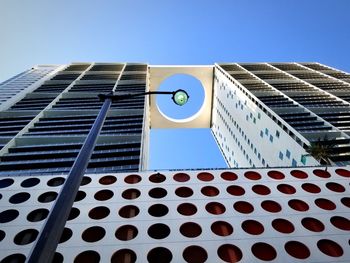 Low angle view of modern building against clear blue sky