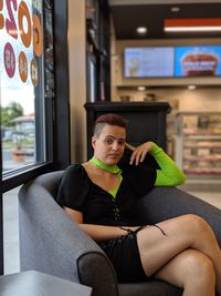 Portrait of woman sitting on chair in cafe