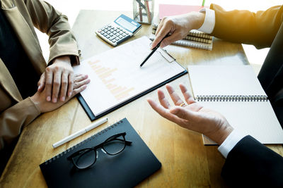 High angle view of people working on table